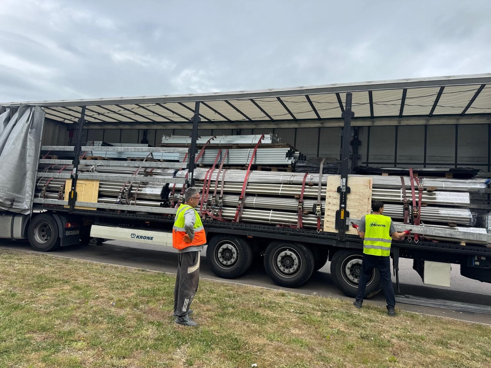 Structural steel strapped down on a flatbed trailer for delivery to site